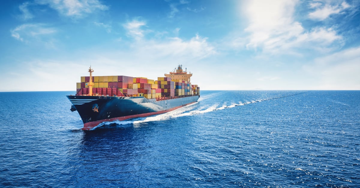 Aerial panorama of a cargo ship carrying container for import and export, business logistic and transportation in open sea with copy space
